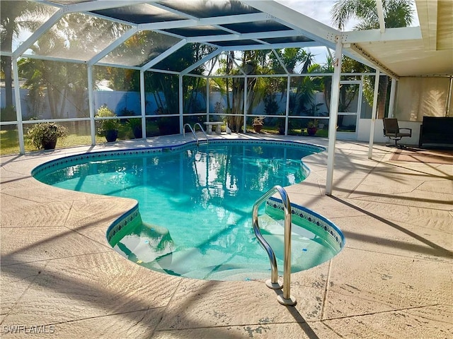 view of swimming pool featuring a lanai and a patio