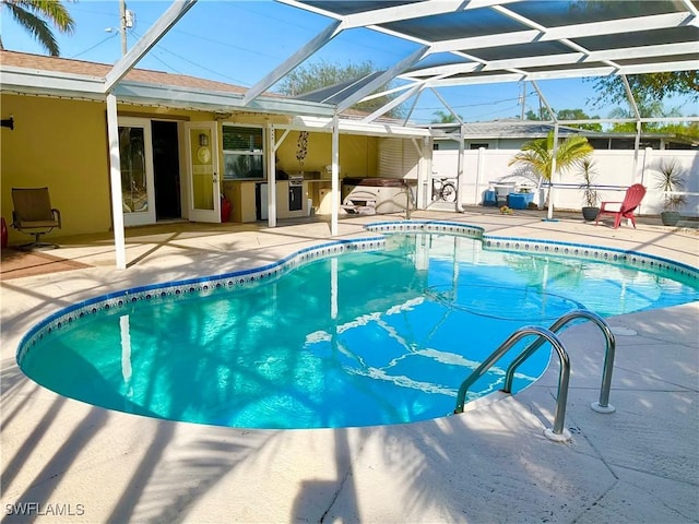 view of pool featuring a patio and glass enclosure