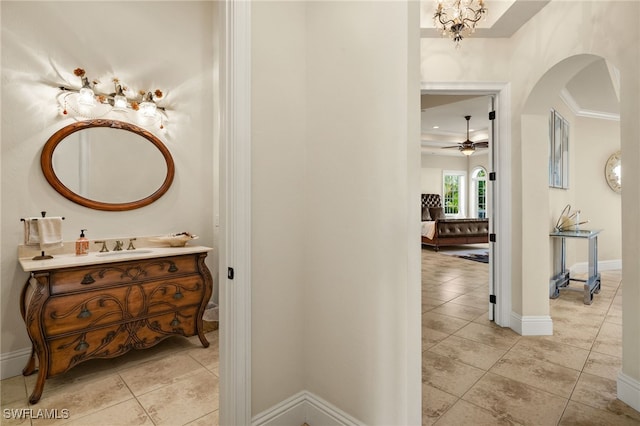 bathroom featuring tile patterned flooring, ceiling fan, crown molding, and vanity