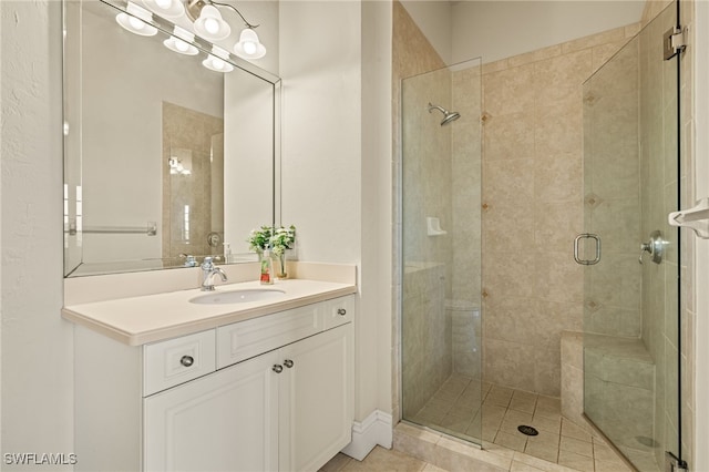 bathroom featuring tile patterned floors, vanity, and a shower with shower door