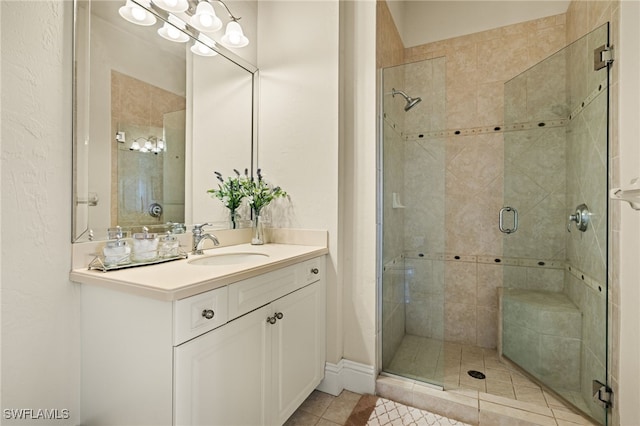 bathroom with tile patterned flooring, vanity, and a shower with shower door