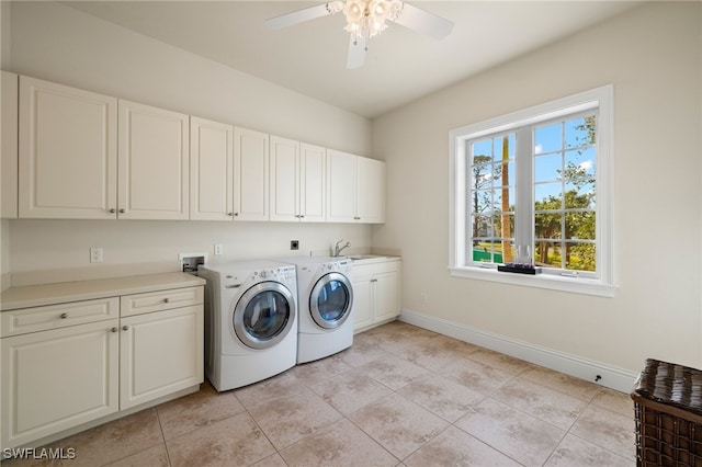 laundry area with cabinets, ceiling fan, sink, washing machine and clothes dryer, and light tile patterned flooring