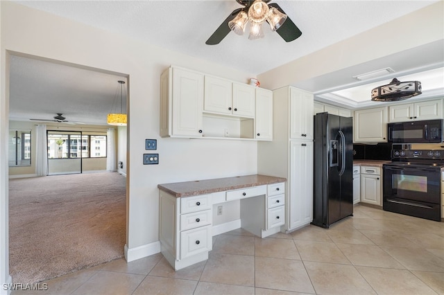 kitchen featuring ceiling fan, a textured ceiling, light carpet, white cabinets, and black appliances