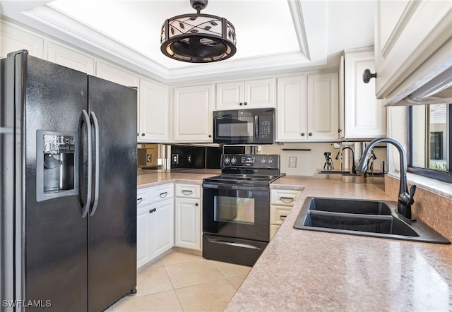 kitchen with black appliances, a raised ceiling, sink, light tile patterned floors, and white cabinetry