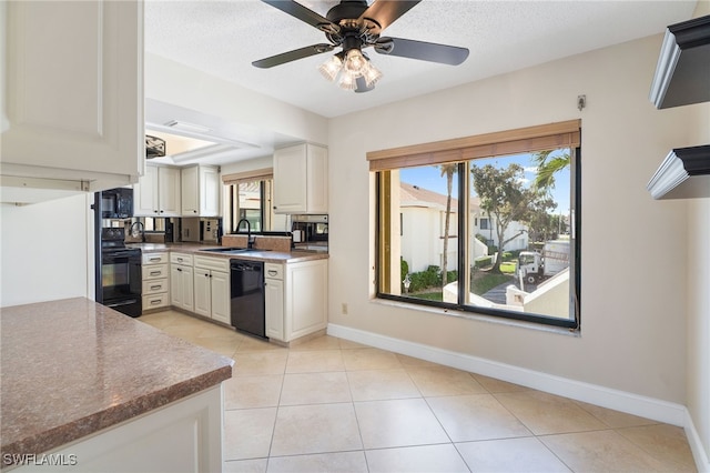 kitchen with ceiling fan, sink, black appliances, light tile patterned floors, and white cabinetry