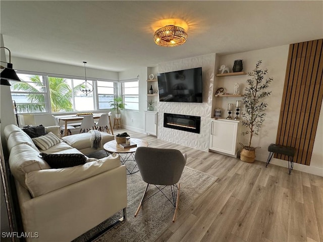 living room with a fireplace and light hardwood / wood-style flooring