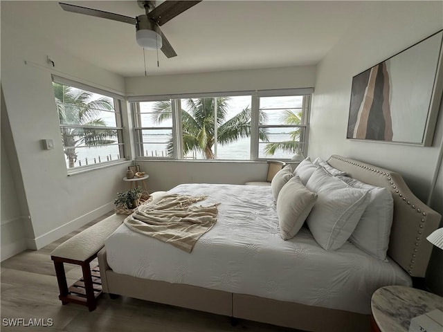 bedroom with ceiling fan and wood-type flooring