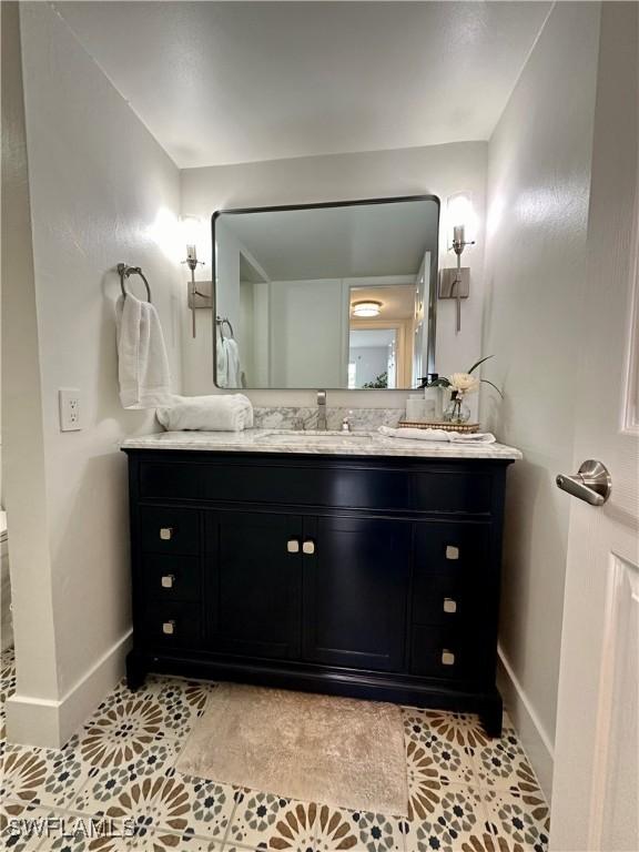 1900 Clifford St Unit 201, Fort Myers, FL 33901 - bathroom featuring baseboards, vanity, and tile patterned floors