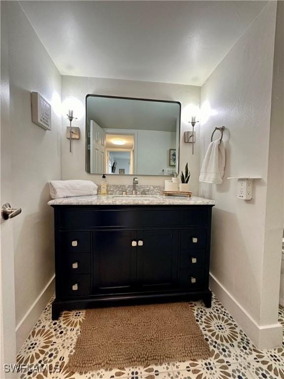 bathroom featuring tile patterned flooring and vanity