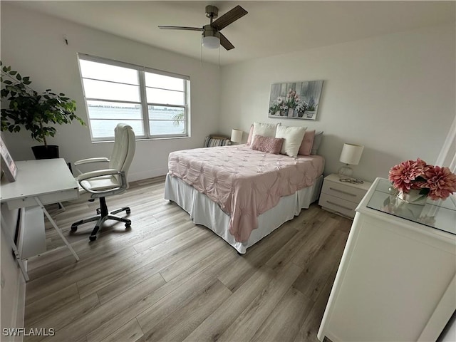 bedroom with light hardwood / wood-style flooring and ceiling fan