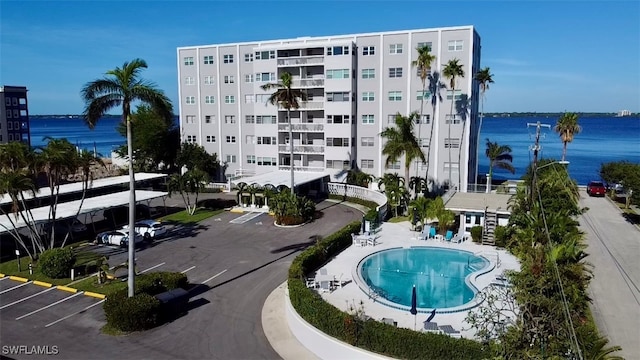 exterior space featuring a water view and a community pool