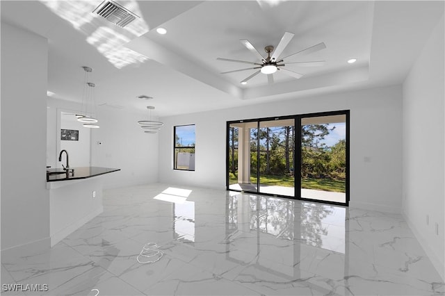 2517 11th St SW, Lehigh Acres, FL 33976 - unfurnished living room featuring baseboards, light marble finish floors, a tray ceiling, ceiling fan, and recessed lighting