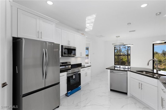 2517 11th St SW, Lehigh Acres, FL 33976 - kitchen with appliances with stainless steel finishes, a sink, recessed lighting, dark countertops, and white cabinets