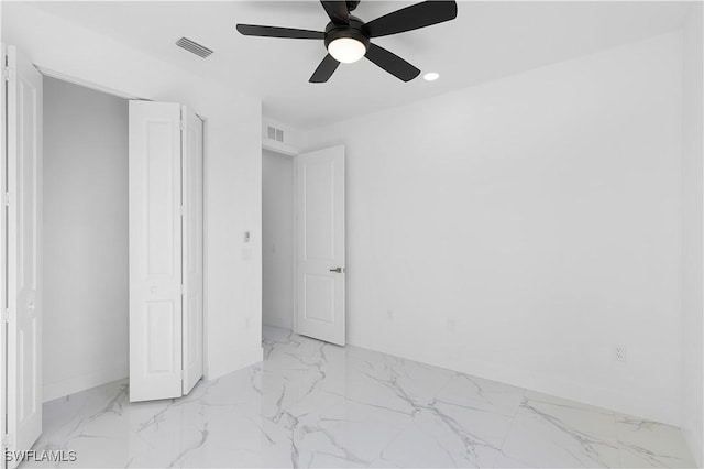 2517 11th St SW, Lehigh Acres, FL 33976 - unfurnished bedroom featuring marble finish flooring, baseboards, ceiling fan, and recessed lighting