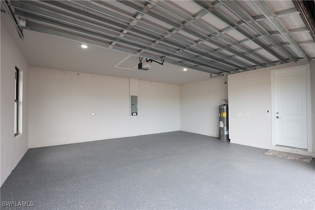 garage featuring electric panel, water heater, and a garage door opener