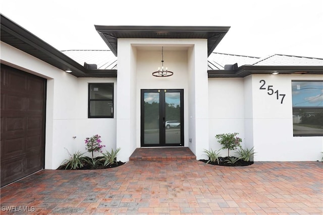 2517 11th St SW, Lehigh Acres, FL 33976 - entrance to property featuring stucco siding, french doors, and a garage