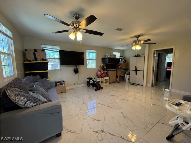 living room featuring a wealth of natural light and ceiling fan