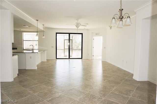 unfurnished living room with ceiling fan with notable chandelier, crown molding, and sink