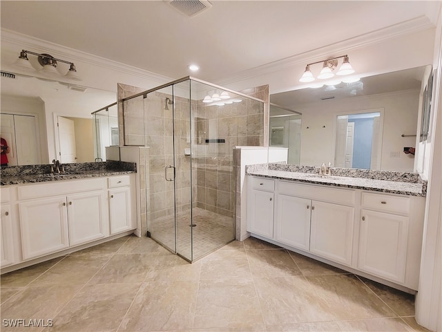 bathroom featuring vanity, an enclosed shower, and ornamental molding