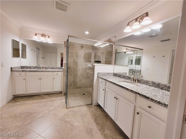 bathroom featuring ornamental molding, vanity, and a shower with shower door