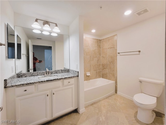 full bathroom featuring vanity, toilet, and tiled shower / bath combo