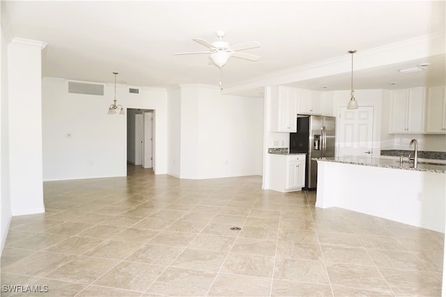 kitchen featuring white cabinets, stainless steel refrigerator with ice dispenser, light stone countertops, and ceiling fan