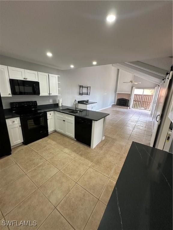 kitchen with black appliances, kitchen peninsula, sink, white cabinetry, and light tile patterned floors