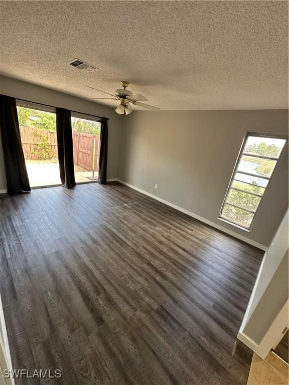 unfurnished room featuring ceiling fan, dark hardwood / wood-style floors, and a textured ceiling