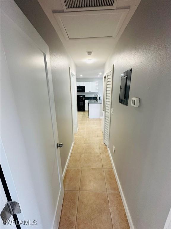 hall with light tile patterned floors