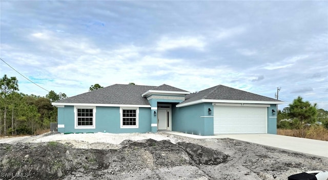 ranch-style home with central AC unit and a garage