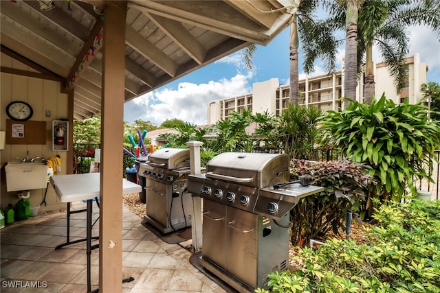 view of patio featuring area for grilling and sink