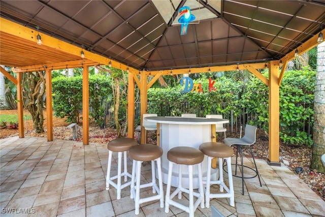 view of patio / terrace featuring a gazebo and exterior bar