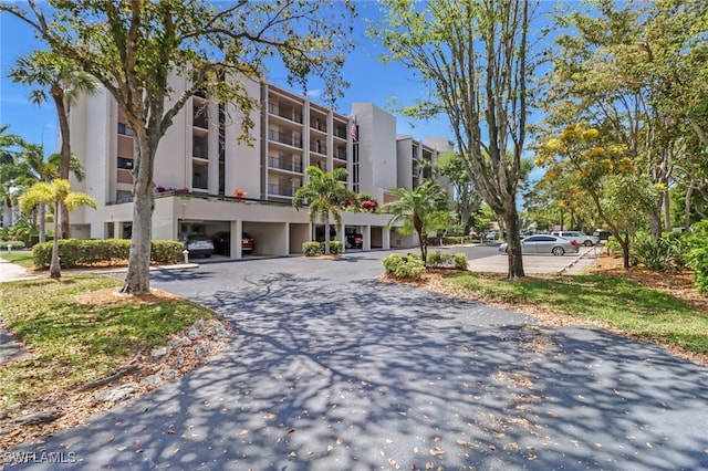 4140 Steamboat Bnd E Unit 502, Fort Myers, FL 33919 - view of apartment building / complex featuring uncovered parking