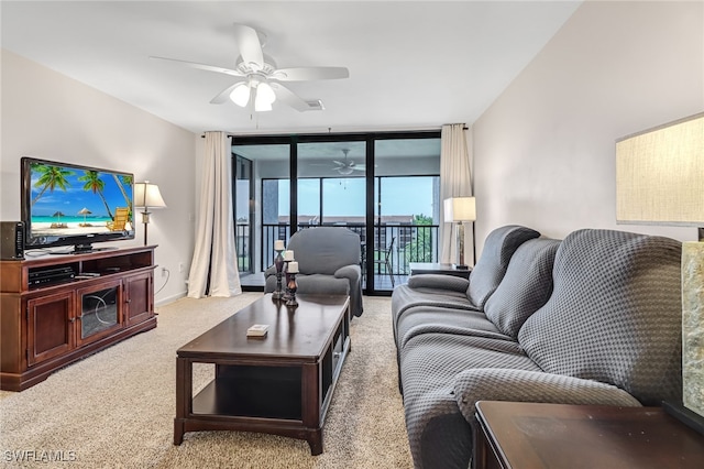 living room with ceiling fan, carpet floors, and a wall of windows