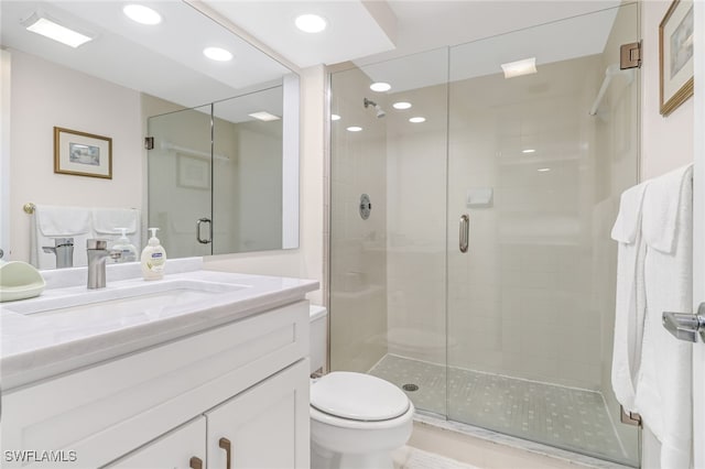 bathroom with vanity, an enclosed shower, and toilet