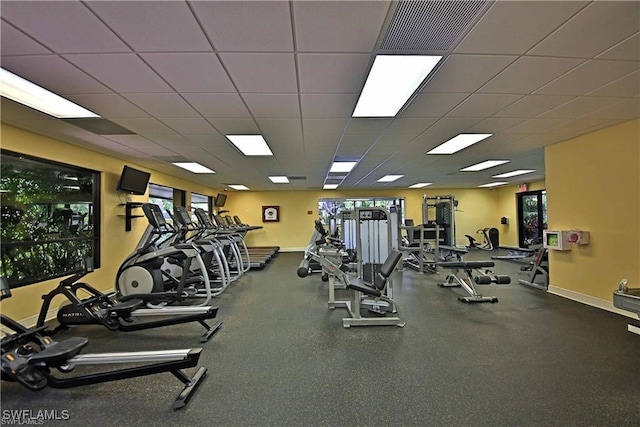 exercise room with a paneled ceiling