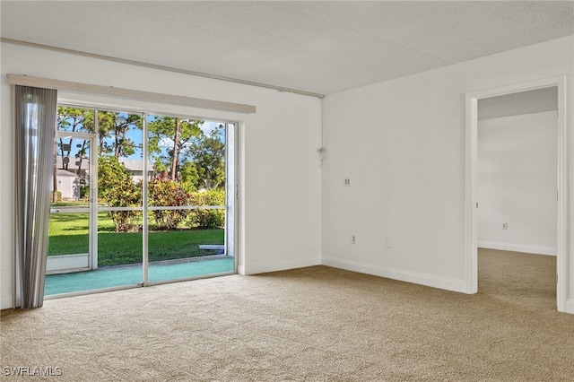 carpeted spare room with a textured ceiling