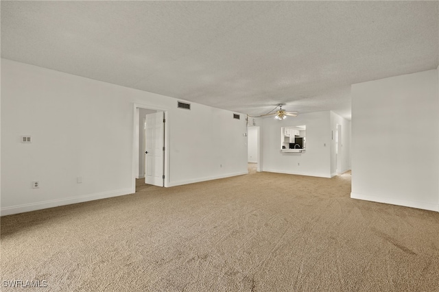 unfurnished living room featuring ceiling fan, carpet floors, and a textured ceiling