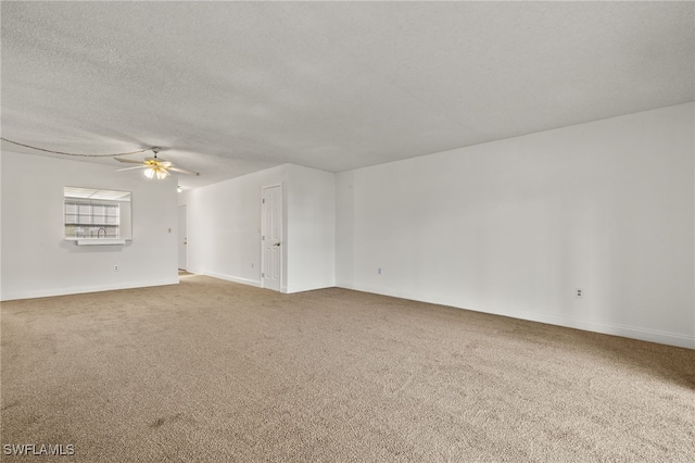 carpeted empty room with a textured ceiling and ceiling fan