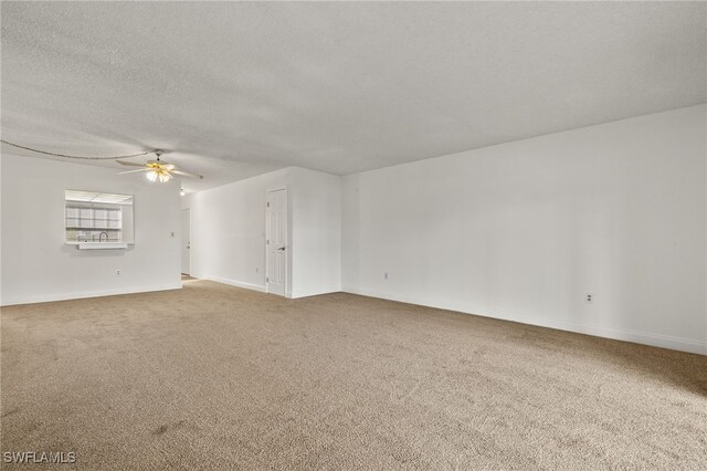 7068 Nantucket Cir Unit 3, North Fort Myers, FL 33917 - unfurnished living room with carpet, a ceiling fan, and a textured ceiling
