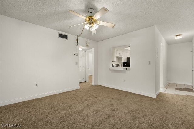 7068 Nantucket Cir Unit 3, North Fort Myers, FL 33917 - empty room featuring light colored carpet, ceiling fan, and a textured ceiling