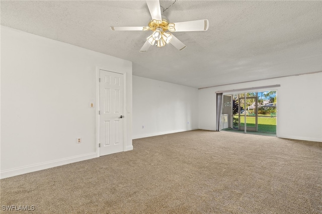 unfurnished room with ceiling fan, carpet floors, and a textured ceiling