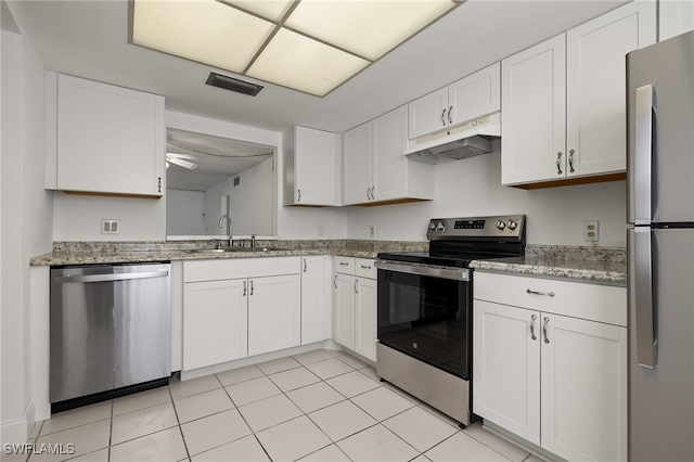 7068 Nantucket Cir Unit 3, North Fort Myers, FL 33917 - kitchen featuring stainless steel appliances, under cabinet range hood, white cabinets, and light stone counters