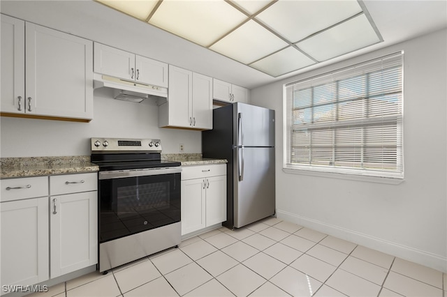 kitchen with light stone counters, white cabinetry, stainless steel appliances, and light tile patterned floors