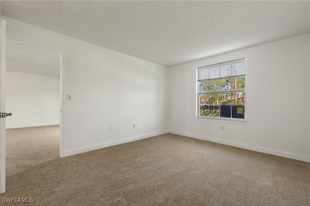 carpeted spare room featuring a textured ceiling