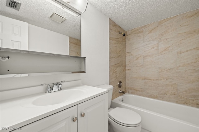 full bathroom with vanity, a textured ceiling, tiled shower / bath combo, and toilet