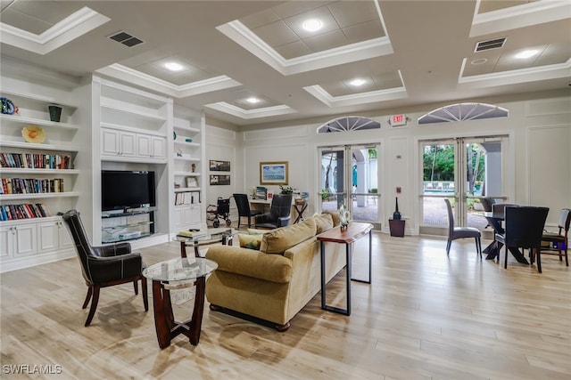 living room featuring french doors, coffered ceiling, built in features, light hardwood / wood-style floors, and ornamental molding