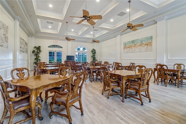 dining space featuring crown molding, beamed ceiling, coffered ceiling, and light wood-type flooring