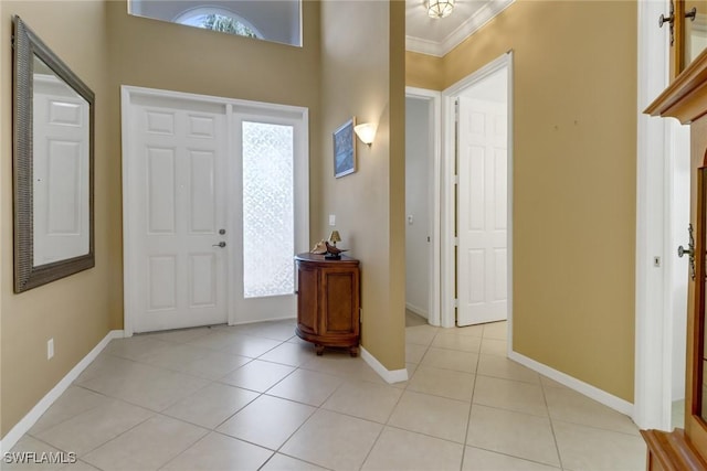 entryway featuring light tile patterned floors and ornamental molding