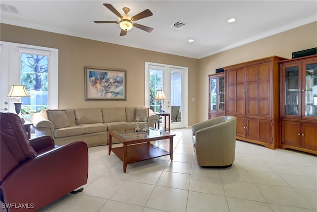 living room with ceiling fan, light tile patterned floors, and crown molding